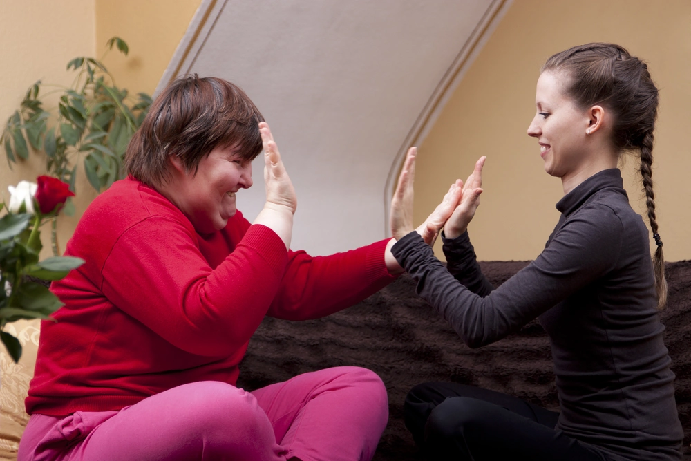 Disabled girl playing with her younger sister
